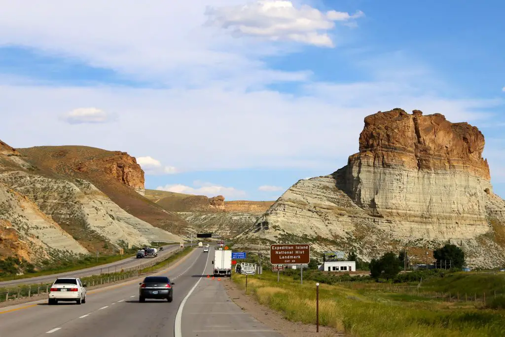 Cars flanked by rock formations.