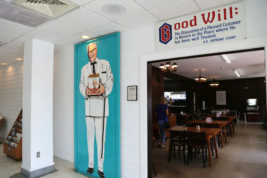 Painting of Col. Sanders alongside the door to seating.