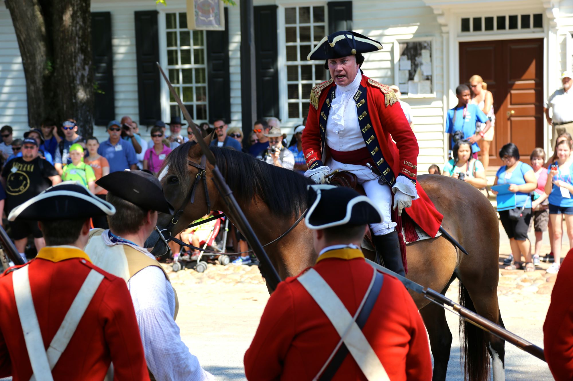 Colonial minute man army leader giving speech to recruits at Williamsburg