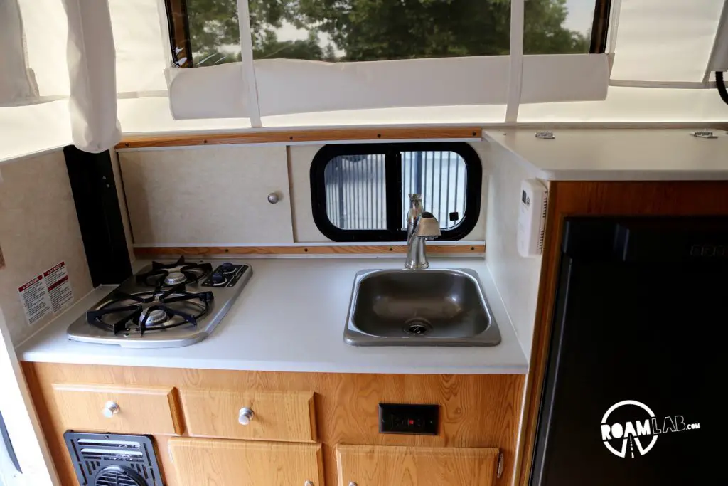 This kitchen space in the pop-top is just too small. The stove to the left has no cover and we didn't find a cover for the sink, either.