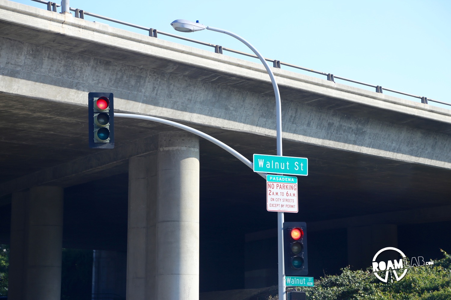 Below the street sign is a smaller sign with smaller print announcing "No parking 2 A.M. to 6 A.M. on city streets except by permit."