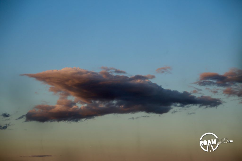 Subtle lines seem to descend from the clouds at sunset, but they are actually whirling tubes of sandflies.