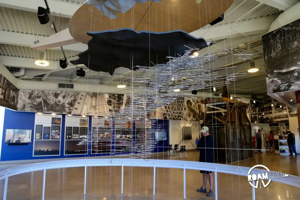 Layers of suspended laser cut metal trace the network of tunnels dug over the life of the Homestake Mine at the Sanford Lab Homestake Visitor Center.
