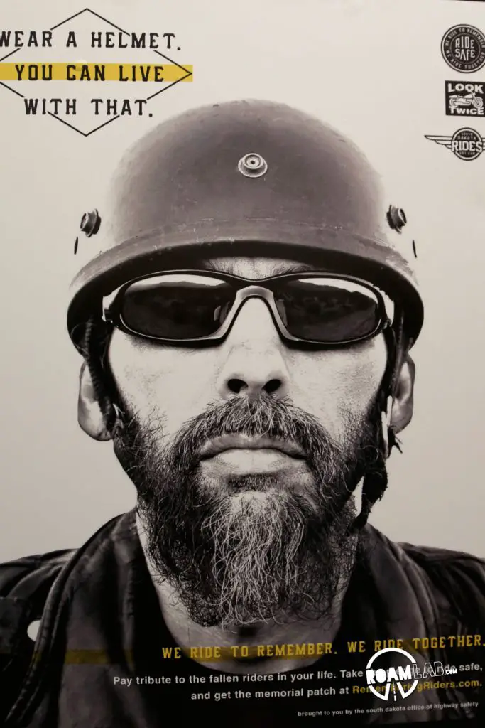 The closer one draws to Sturgis (both the physical town and the Rally's date) the more motorcycle safety ads plaster any available space.  This means creepy biker heads on the insides of bathroom stalls, staring at you while you attempt to complete your business.