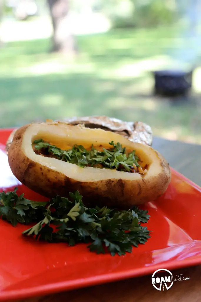 Stoke up that fire for an amazingly delicious Hiker's Bacon And Egg Potato Boat Breakfast
