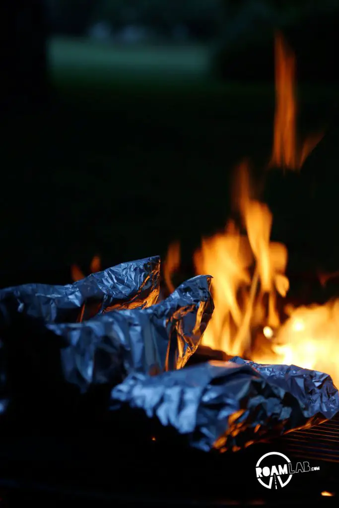 Baking the potatoes in cream sauce over the fire.