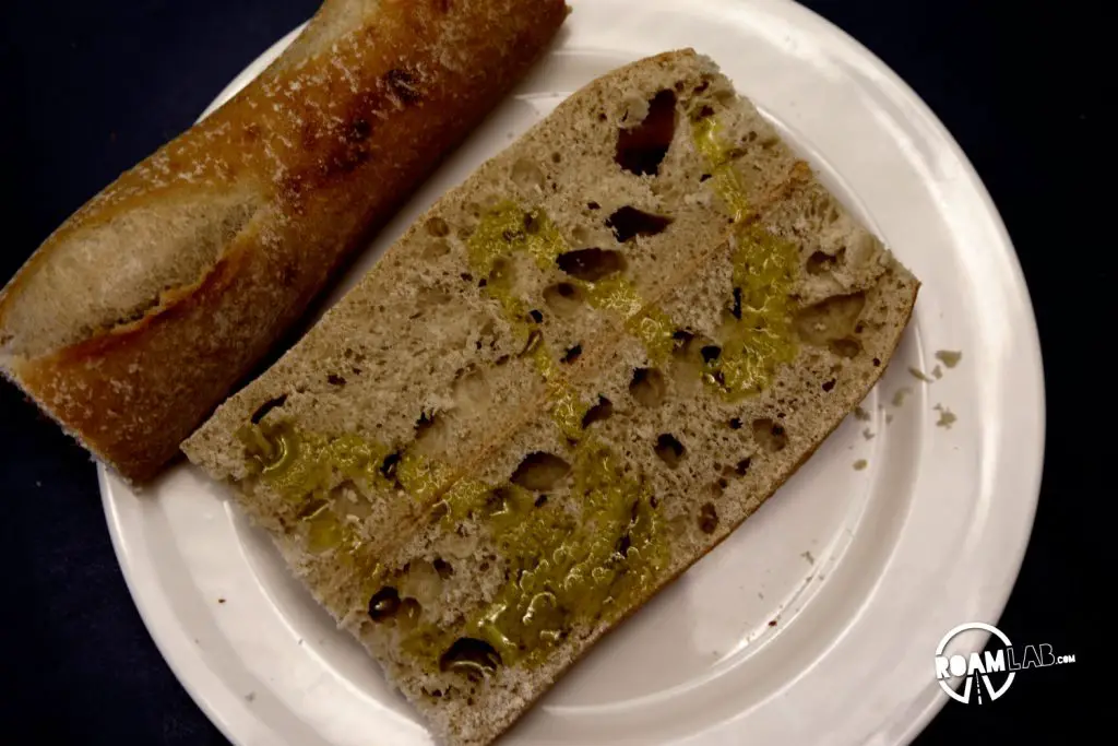 Baguette and olive oil. The making of a delicious Class in the Campground Prosciutto Mozzarella Sandwich.