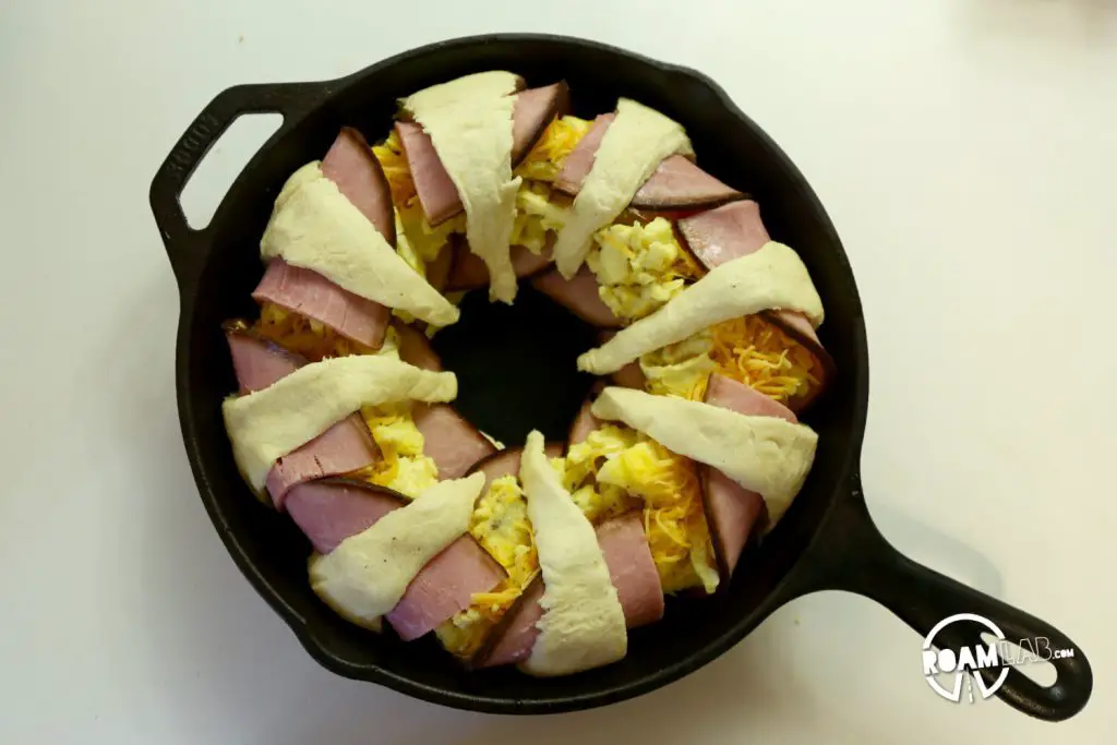 We had a left over tube of crescents and slices of ham, so we decided to bring those two together to make a fun and tasty breakfast combo: the  Dutch Oven Breakfast Ring