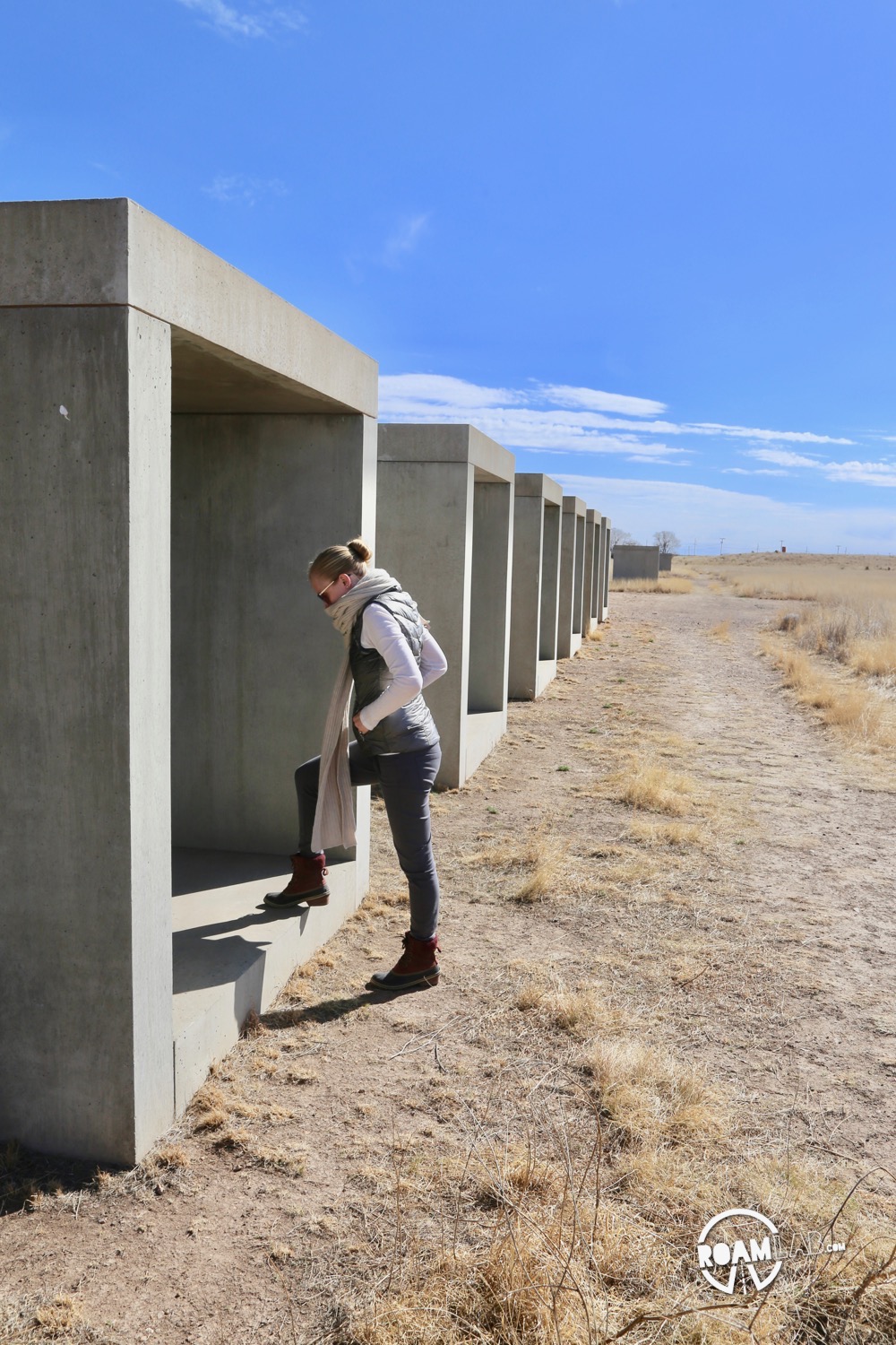 Exploring a collection of concrete sculptures by Donald Judd outside the Chinati Foundation.