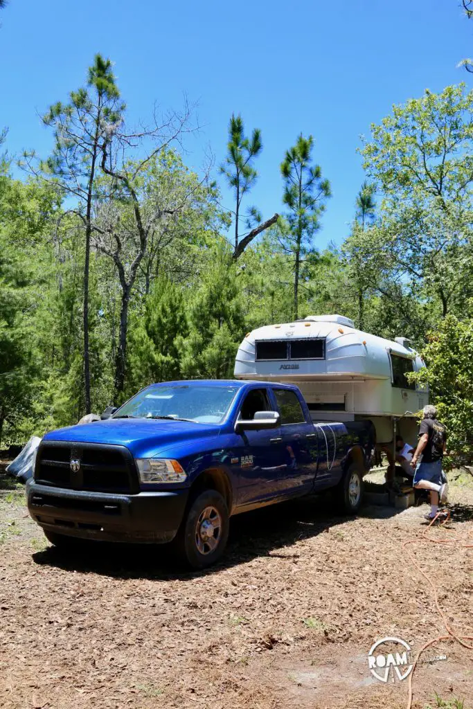 1970 Avion C11 truck camper on jacks in the previous owners back yard with out 2015 Ram 3500.