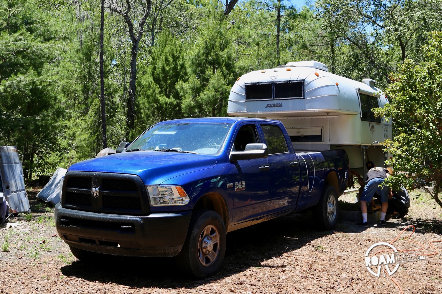 1970 Avion C11 truck camper on jacks in the previous owners back yard with out 2015 Ram 3500.