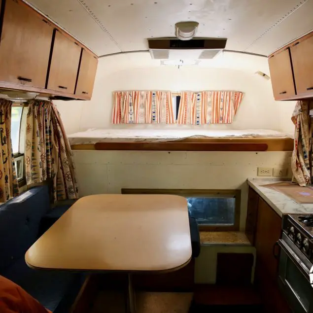 Interior view facing the bed of a 1970 Avion C11 truck camper.