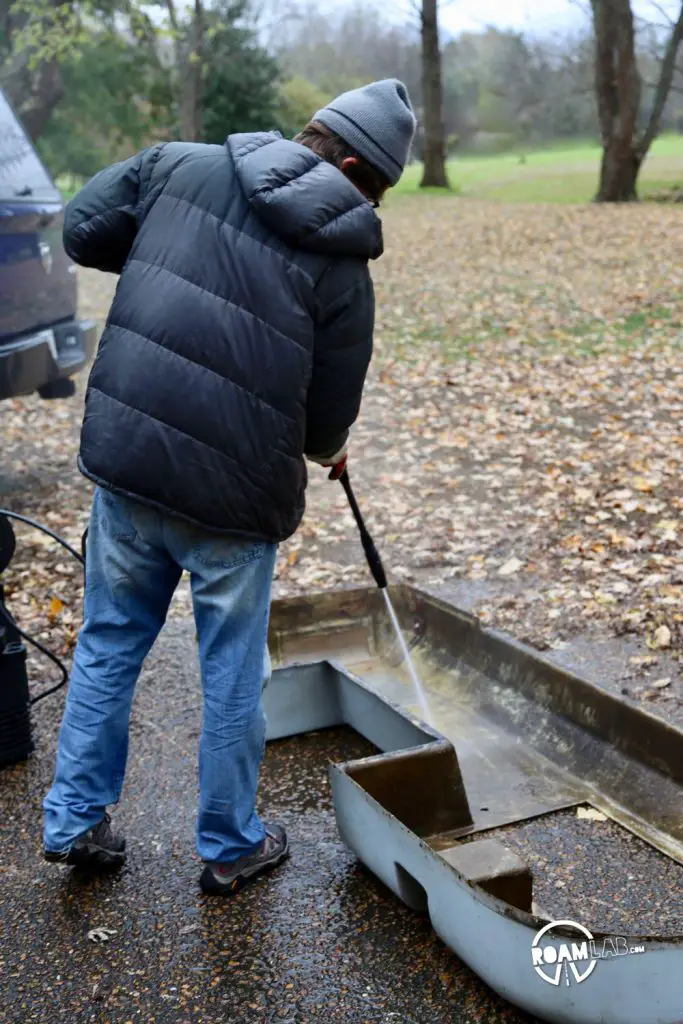 Power-washing the interior and incredibly grimy portion of the fiberglas pan.