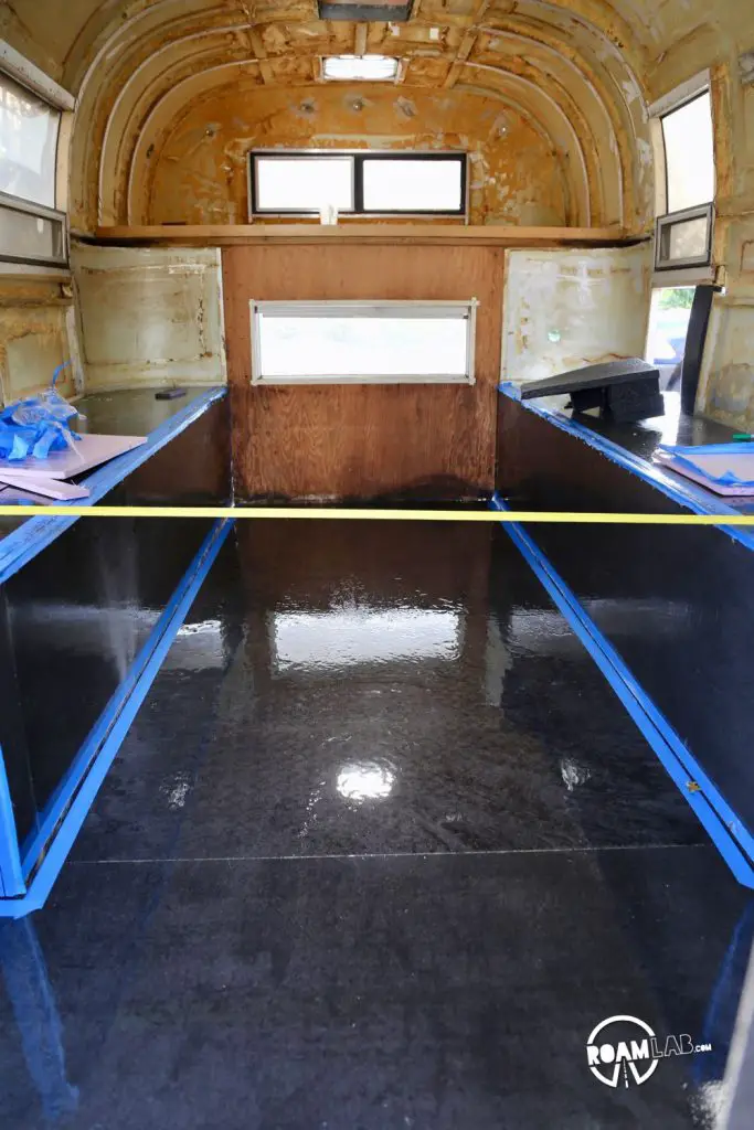 Winching the truck camper body in tight with the floor to screw it back together!