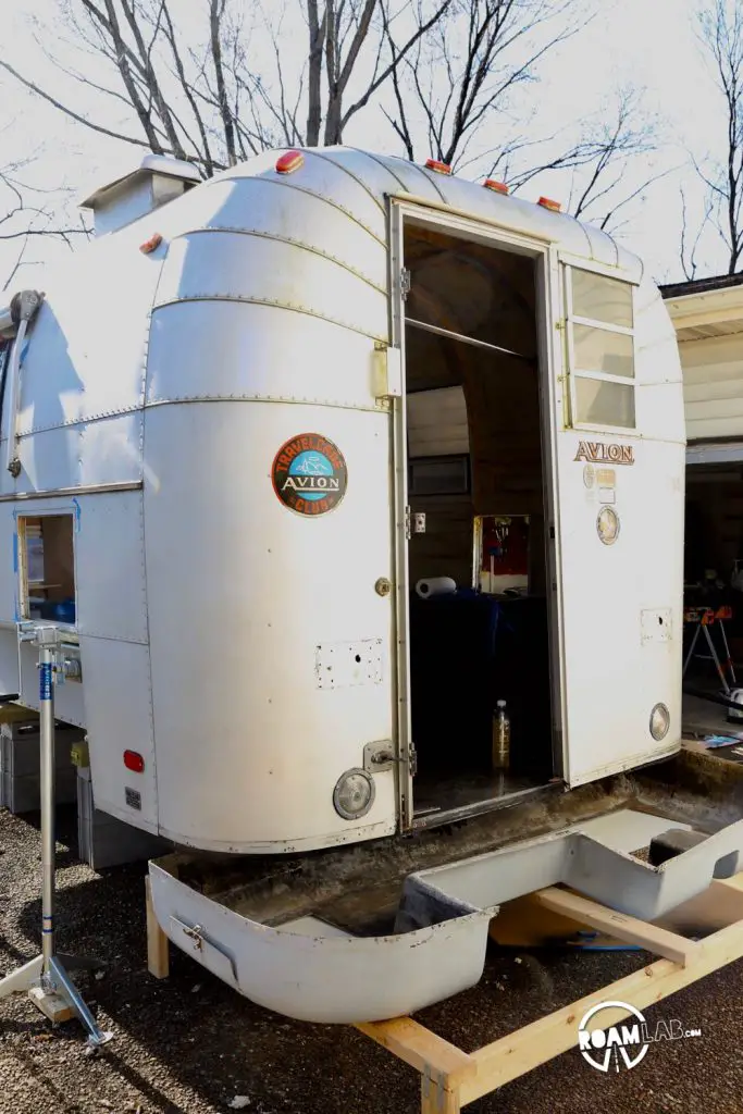 Pan positioned below the camper floor to be raised and screwed back into position.