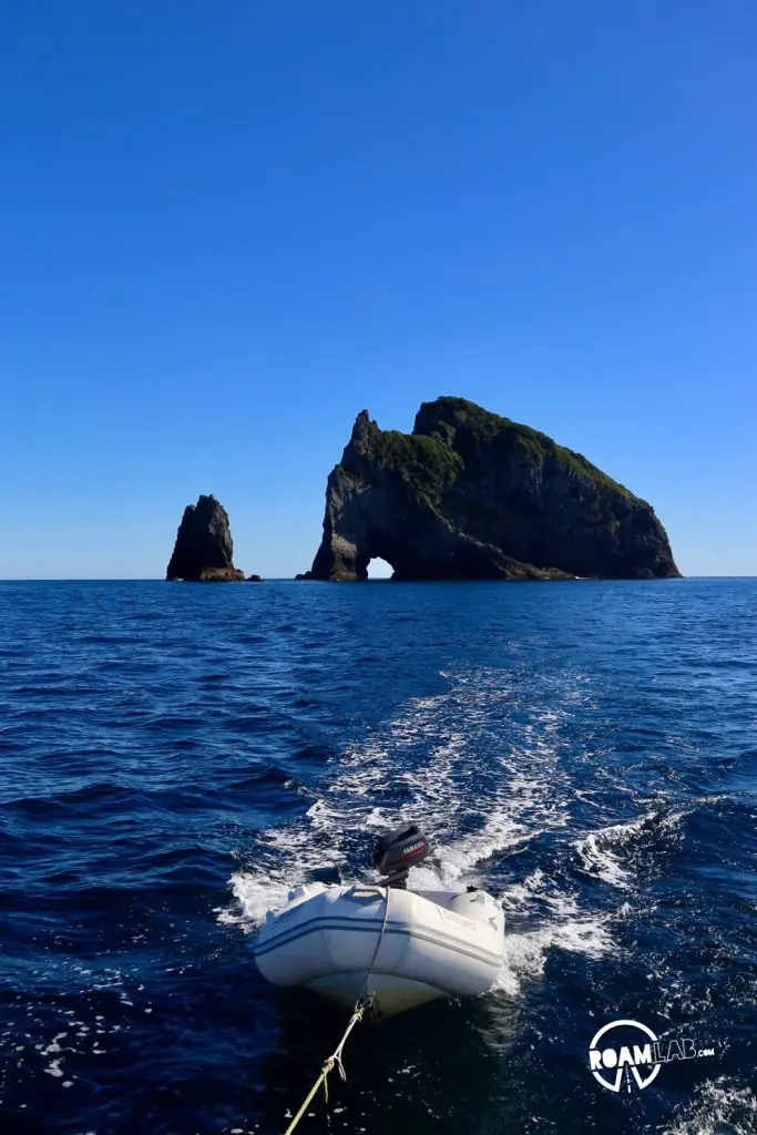 Sailing to Whangamumu Harbour from Motuarohia Island via "The Hole In The Rock” on Motu Kōkako (aka Piercy Island), New Zealand.