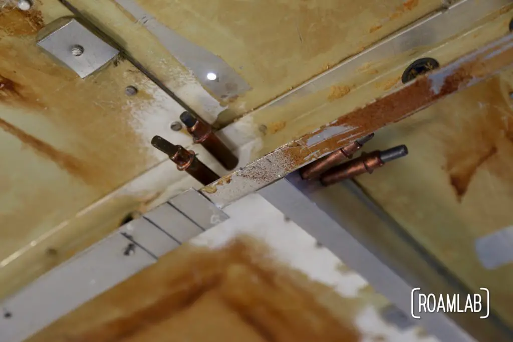 Clecos holding new brackets in place while renovating a vintage 1970 Avion C11 truck camper.