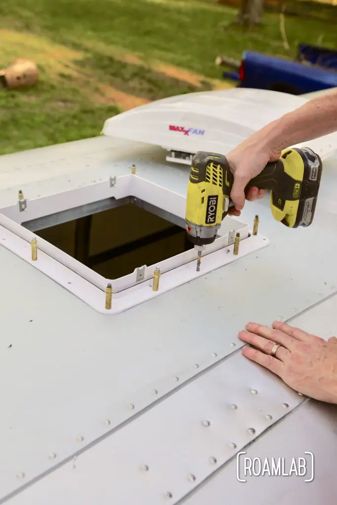 Drilling the remaining holes to rivet frame in place for a DIY MaxxAir Fan installation.
