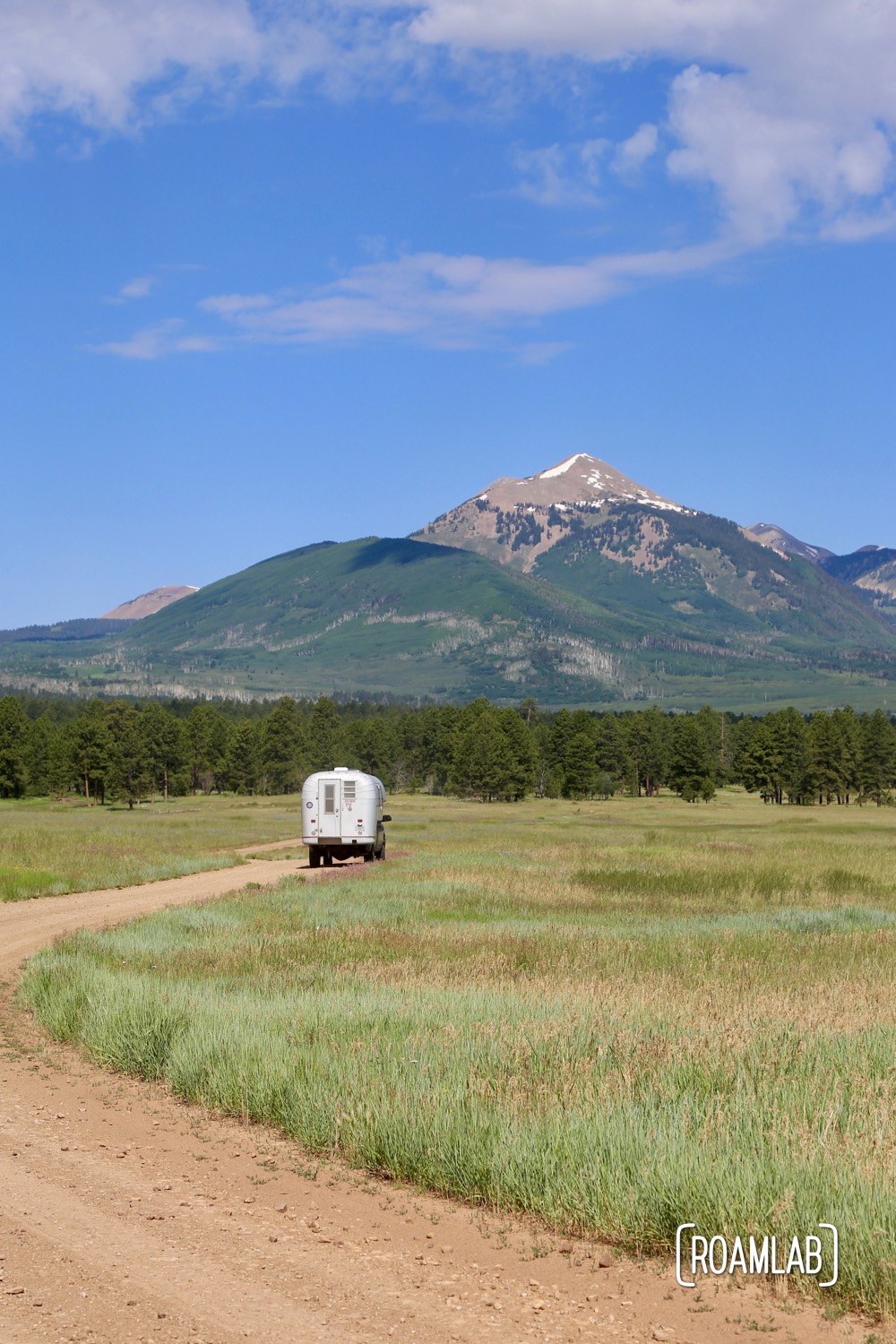 Vintage truck camper crossing over into Utah's wide open prairies.