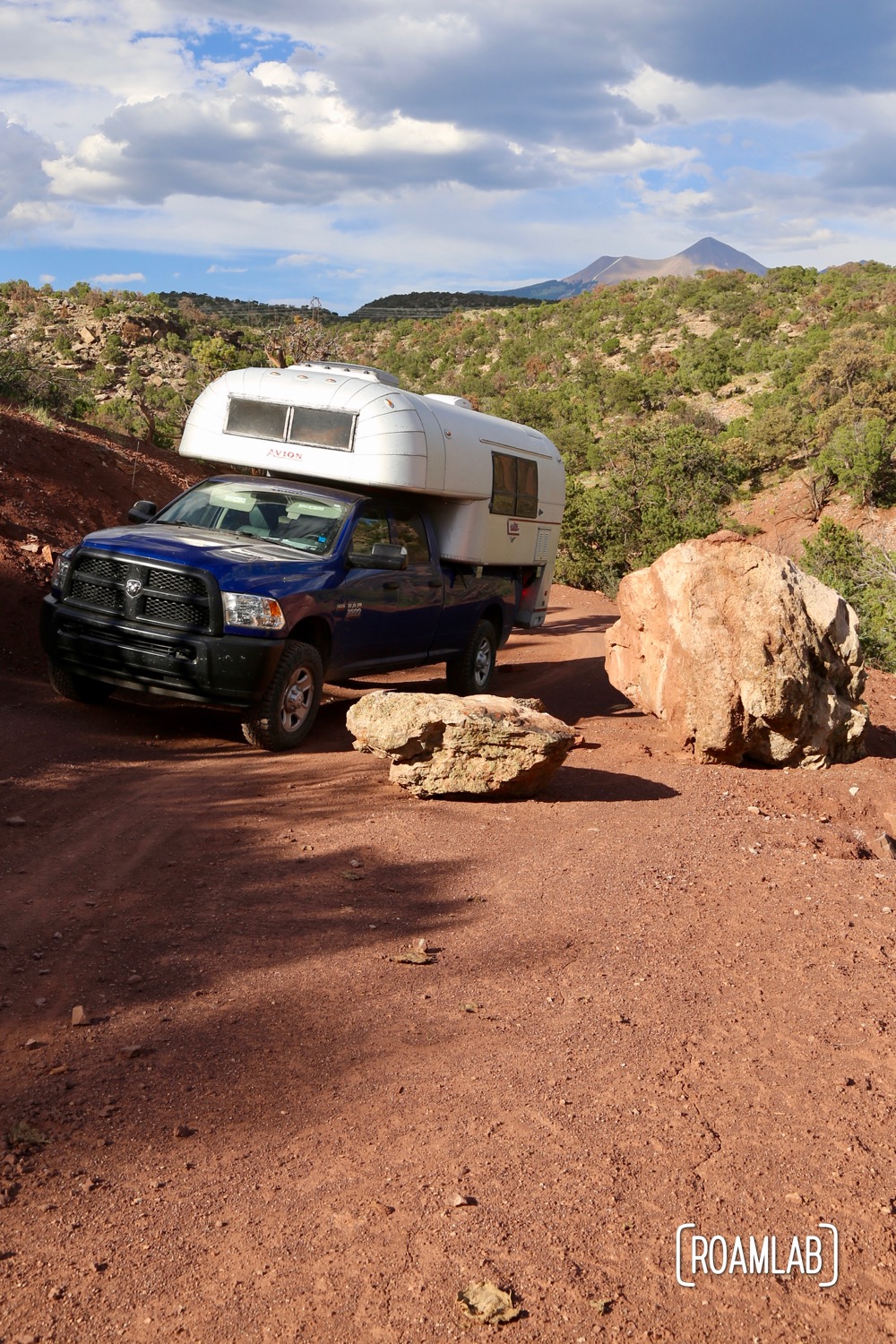 Truck camper driving red dirt roads outside Moab, Utah.