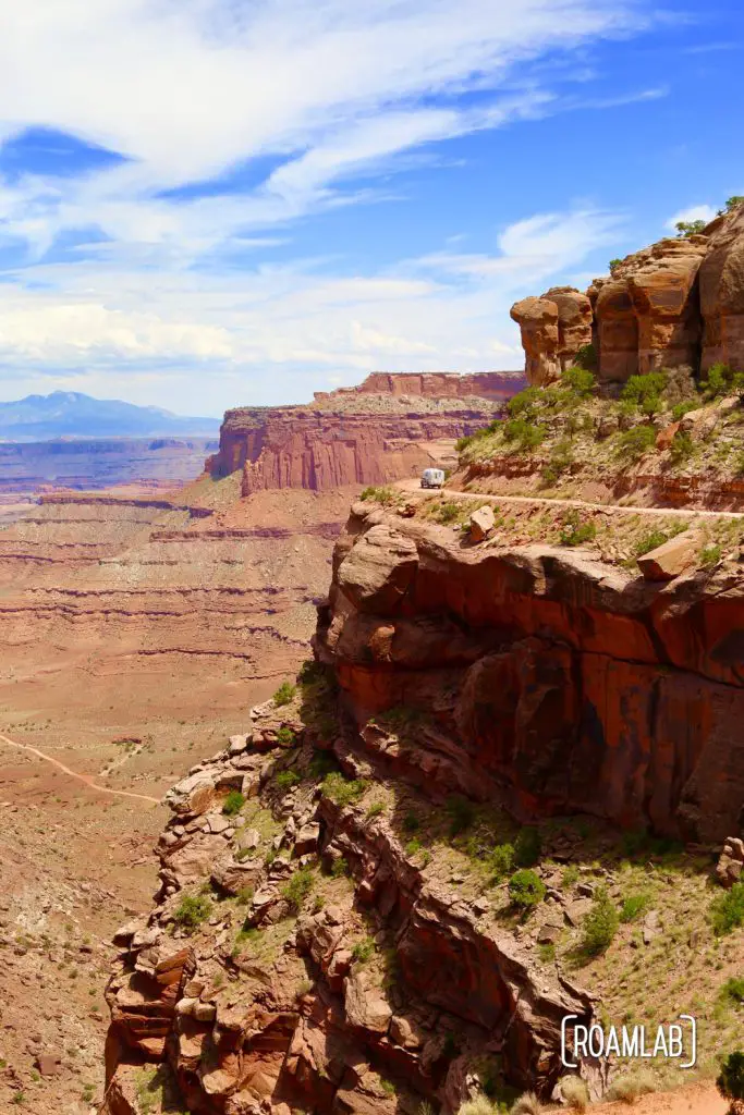 Aluminum Avion C11 truck camper driving down Shafer Road through Canyonlands National Park.