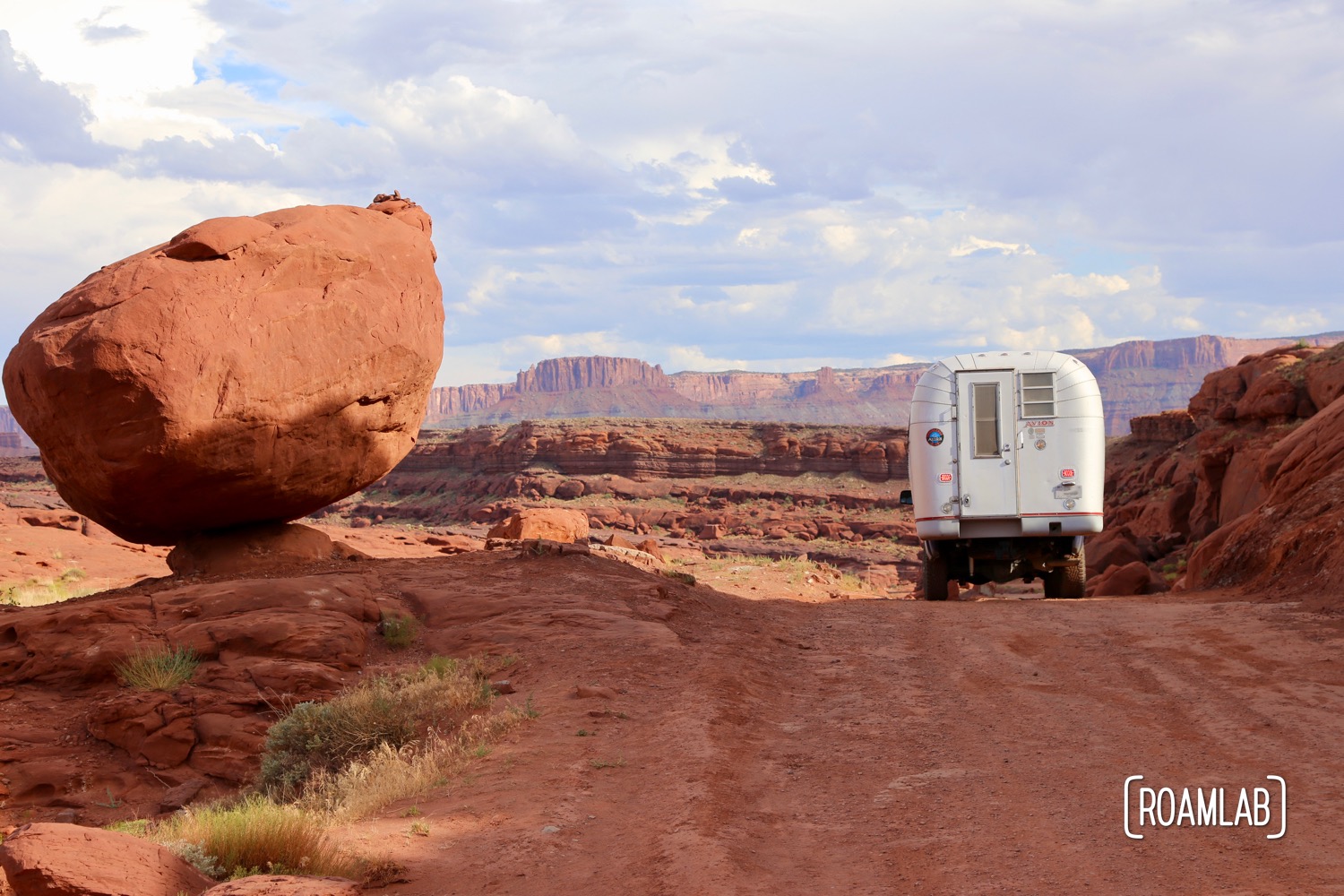 Aluminum Avion C11 truck camper driving down Shafer Road through Canyonlands National Park.