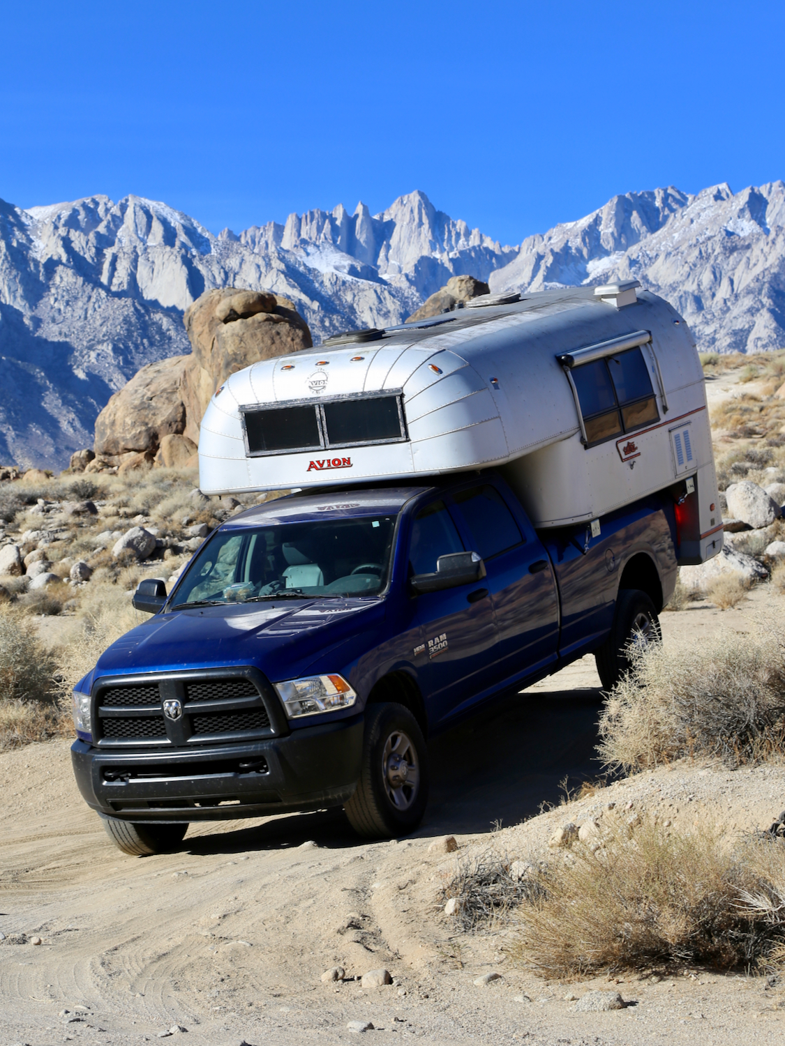 Aluminum truck camper on a blue truck exploring the Eastern Sierras of California