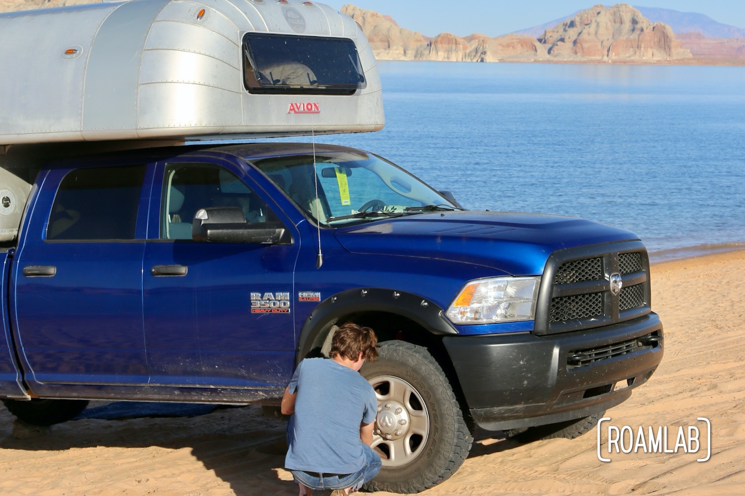 Airing down the tires of a truck camper when driving on the sand.