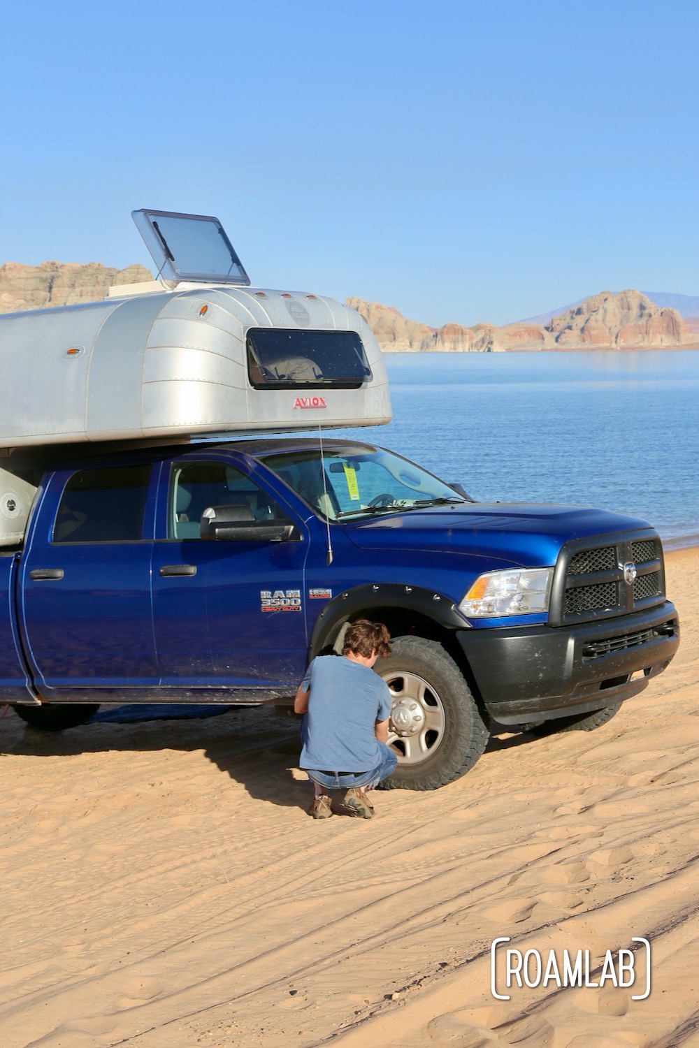 Airing down the tires of a truck camper when driving on the sand.
