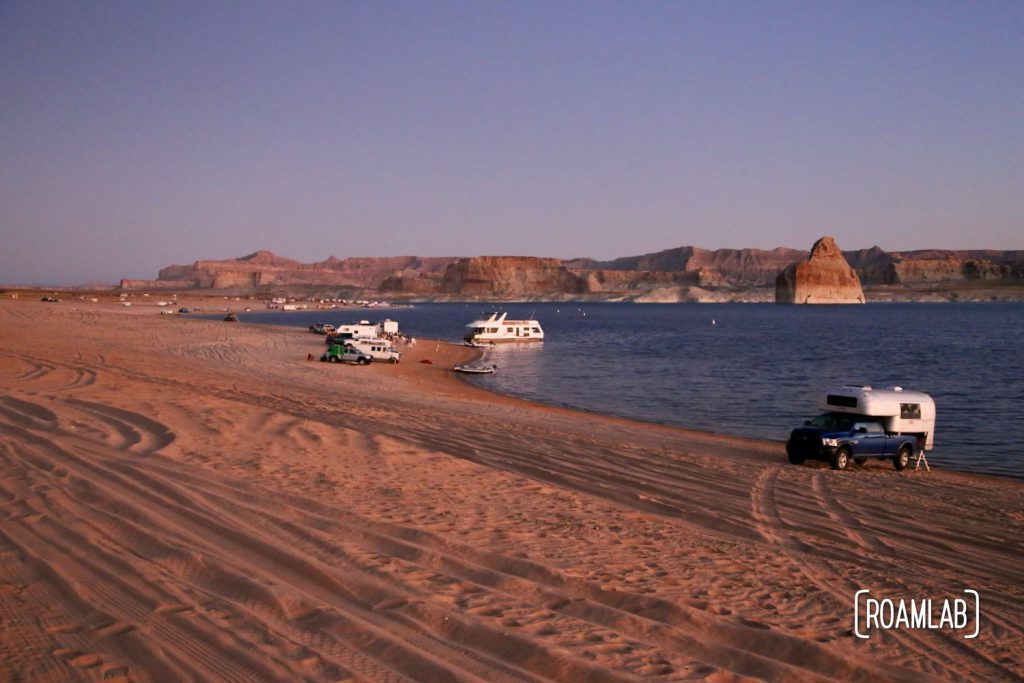 Beach camping along Lake Powel for off-road vehicles at Lone Rock Campground in Glen Canyon National Recreation Area just north of Page, Arizona.