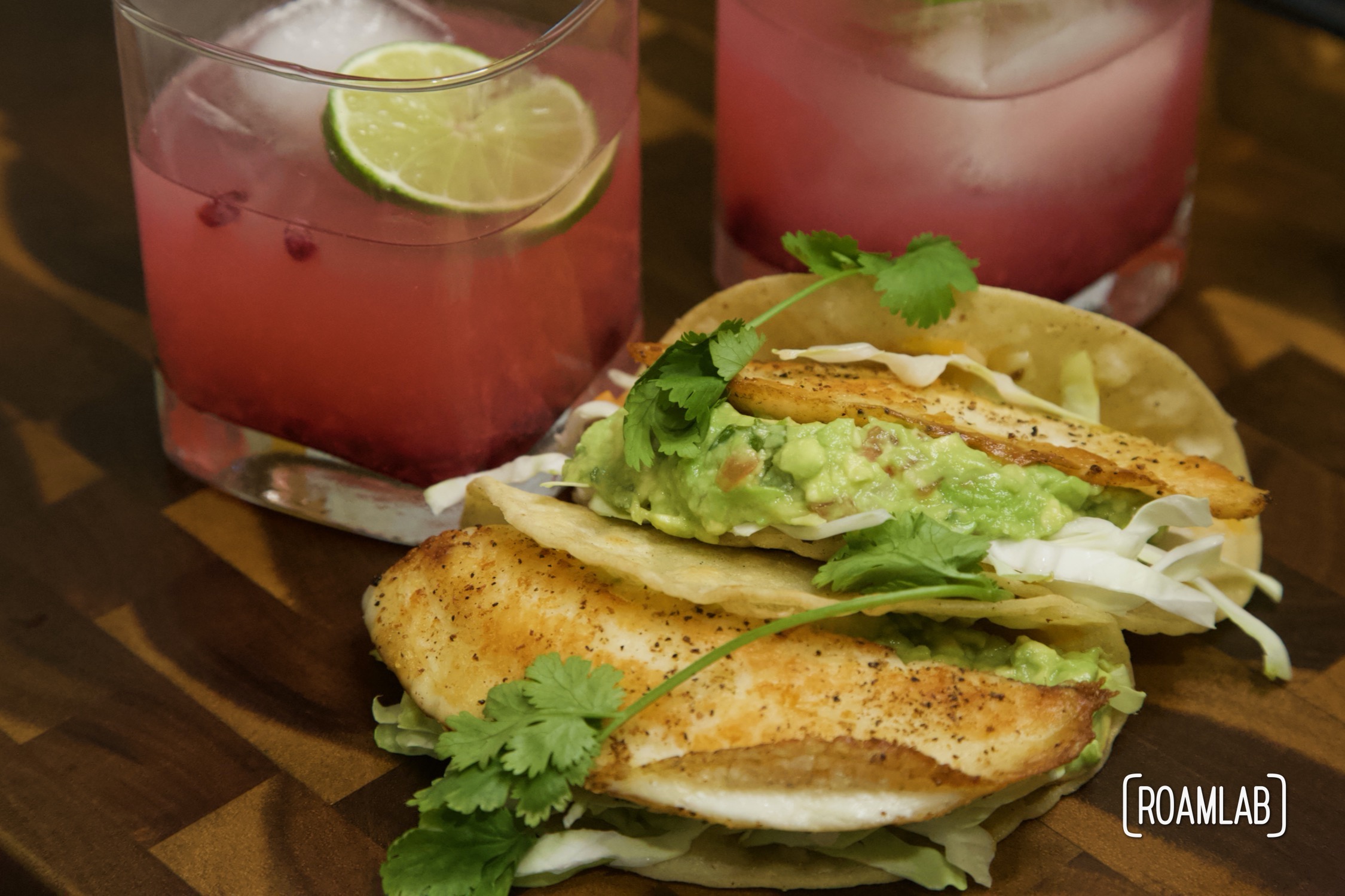 Tilapia fish tacos with guacamole and pomegranate margaritas.