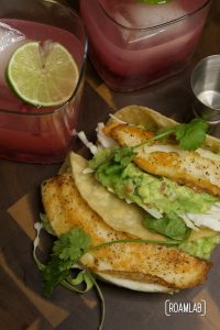 Tilapia fish tacos with guacamole and pomegranate margaritas.