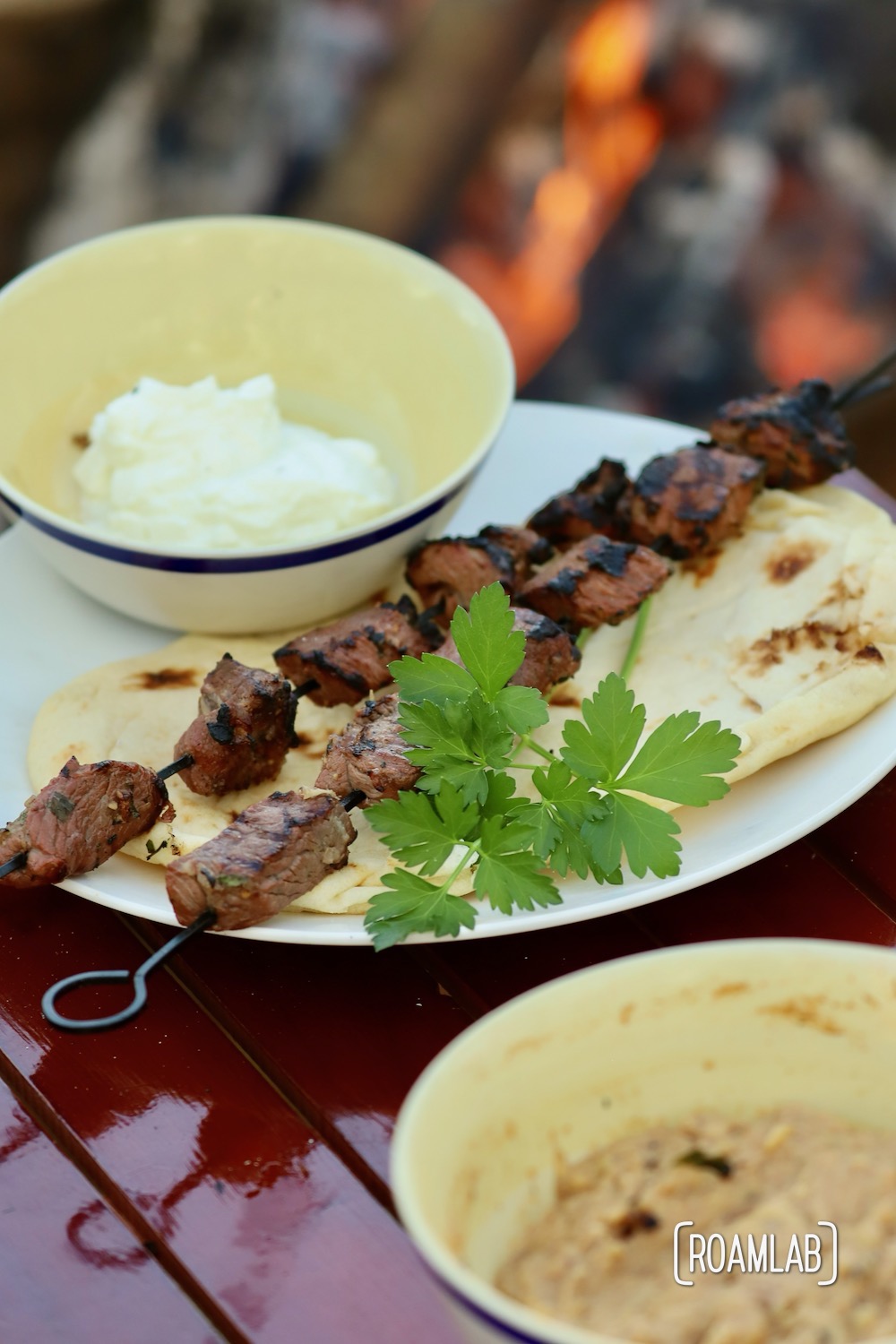 Grill this savory middle eastern Lamb Kabob campfire cooking dinner recipe with a side of toasted pita bread and yogurt for a delicious al fresco meal.