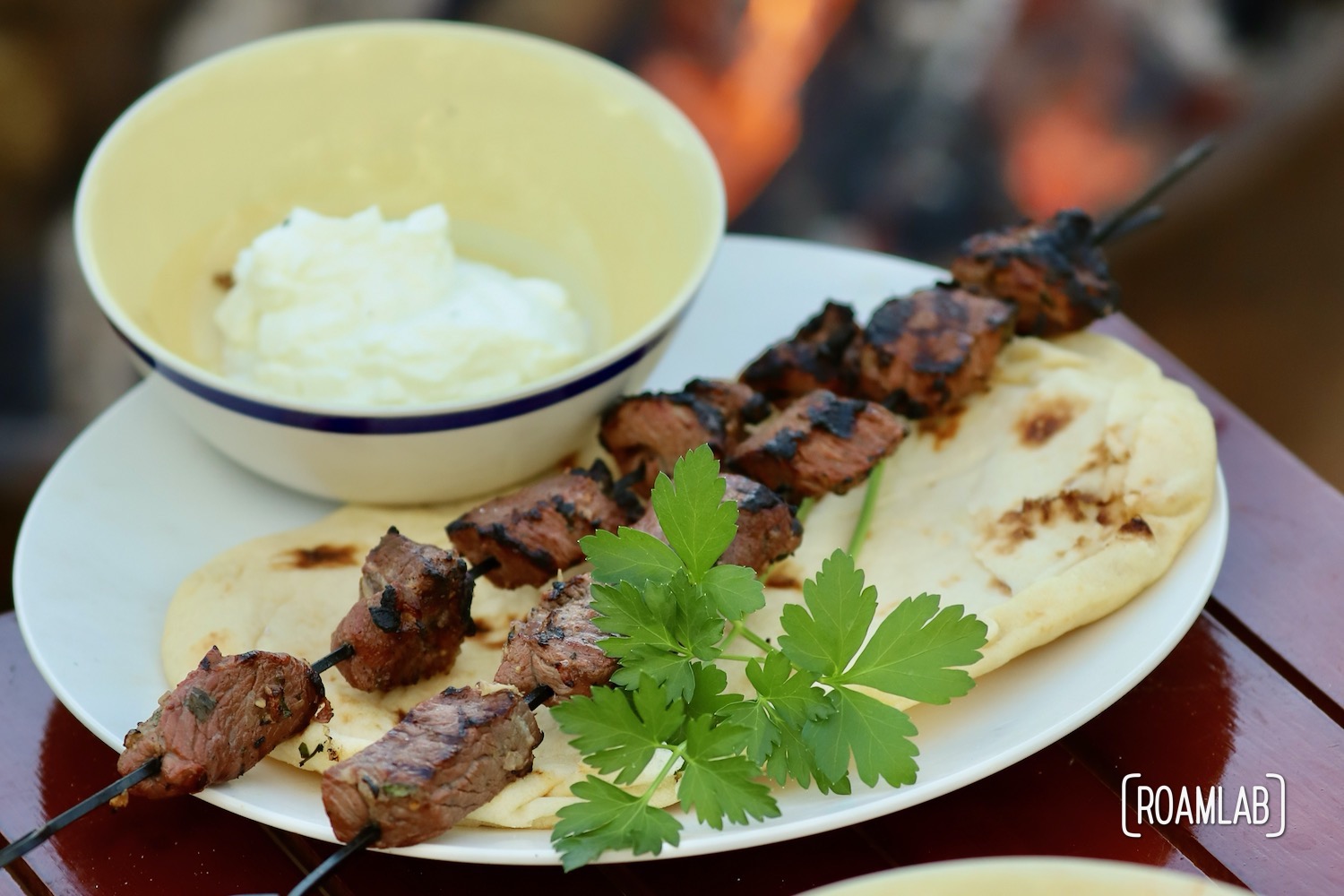 Grill this savory middle eastern Lamb Kabob campfire cooking dinner recipe with a side of toasted pita bread and yogurt for a delicious al fresco meal.