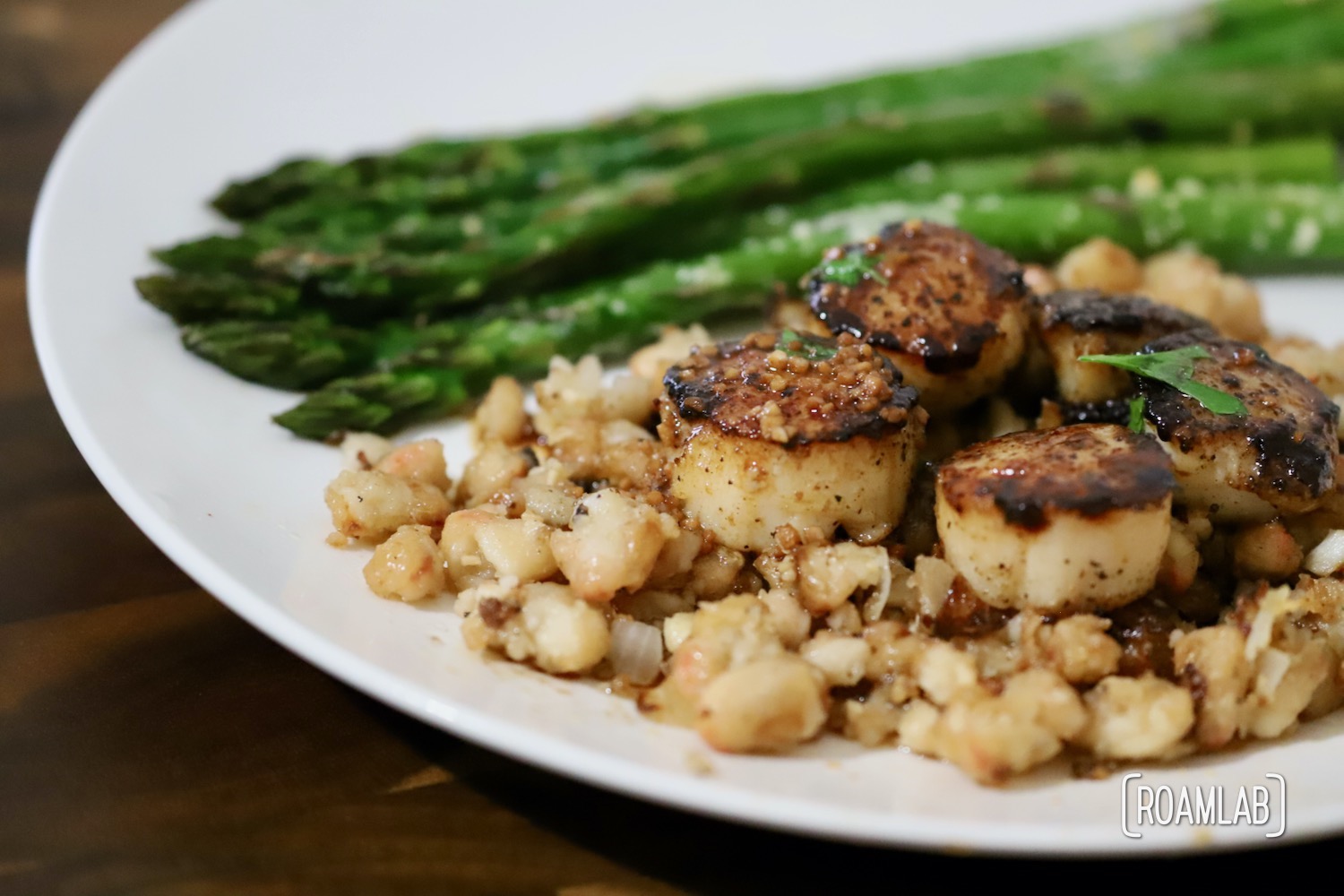 Enjoy this seafood delight of seared sea scallops on a bed of parmesan white beans for a campfire cooking dinner recipe treat from the Roam Lab team.