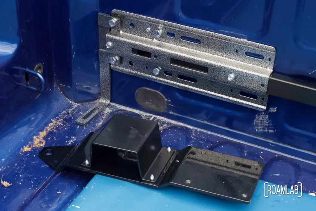 The four open holes on the front anchor plate match up to the set of four large bolts in place on the guide plate.