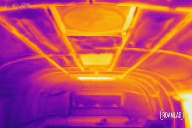 Thermal image of truck camper cabover highlighting aluminum struts, windows, and fan.