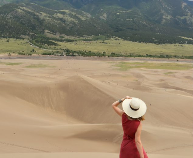 Woman looking out to the mountains in Great Sand Dunes National Park