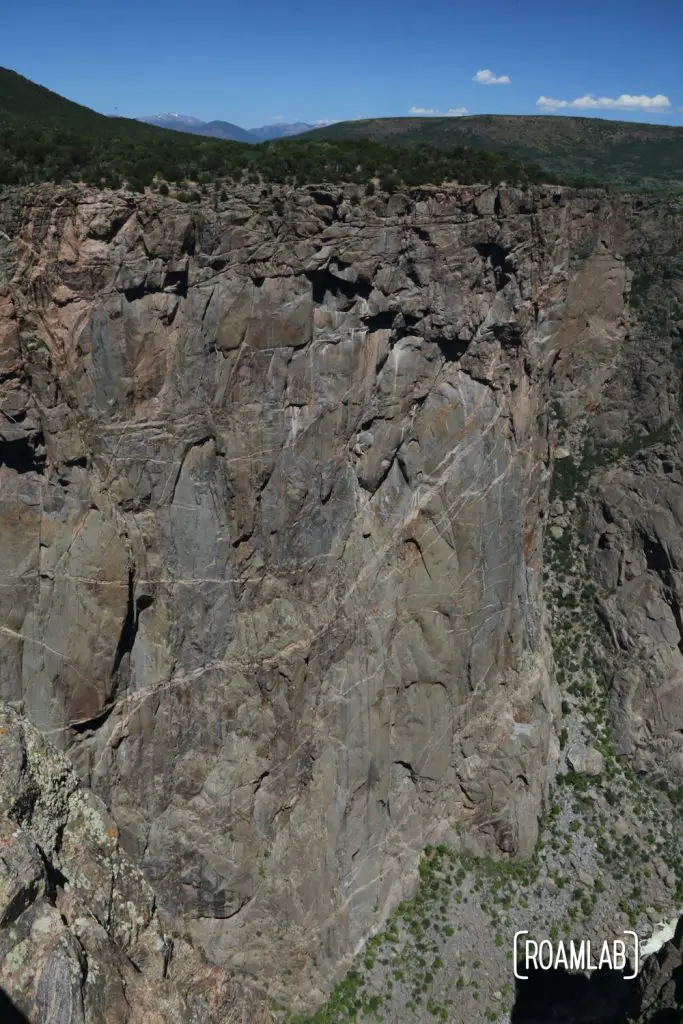 Looking down a sheer cliff in the Black Canyon of the Gunnison National Park in Colorado