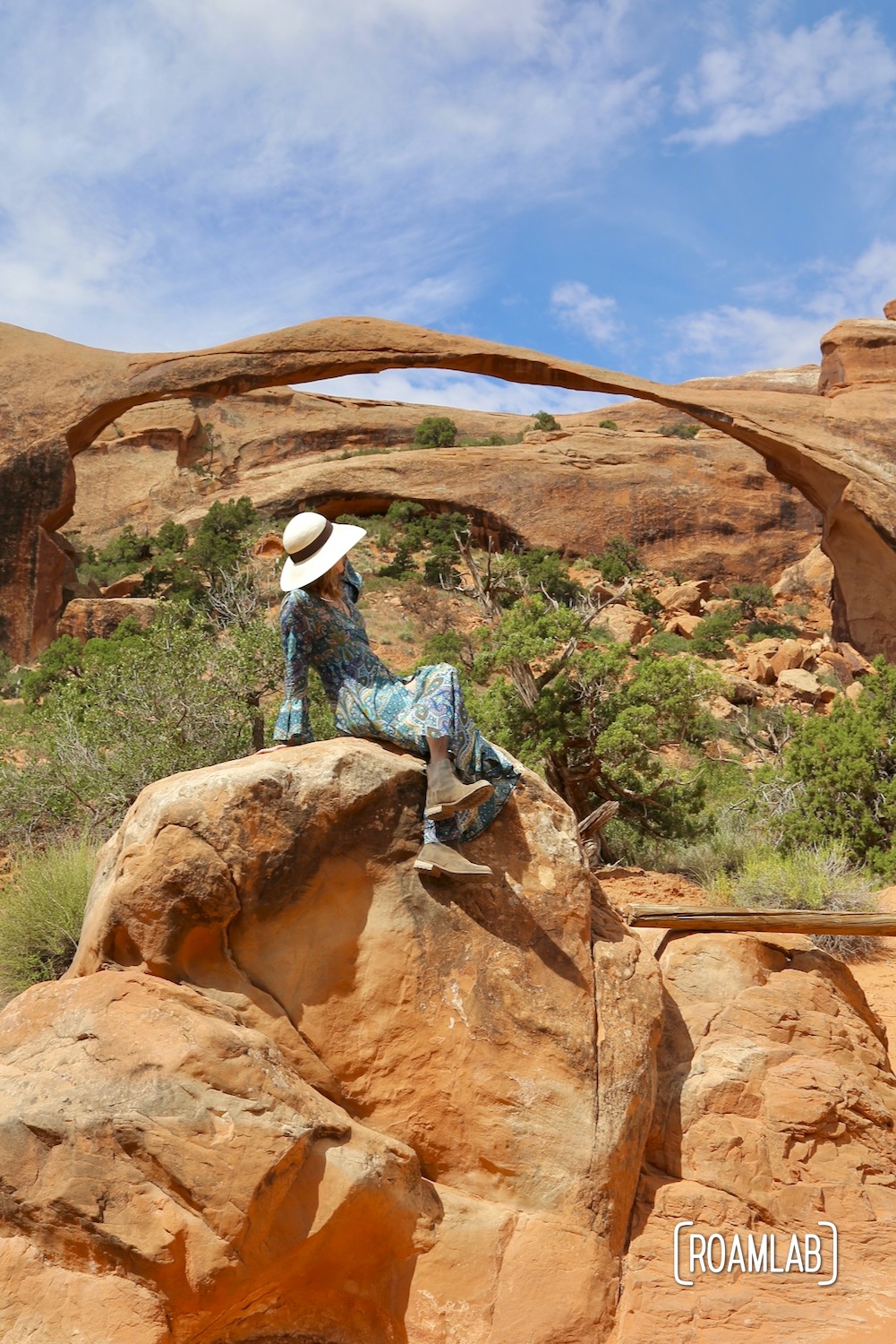Woman in front of Landscape Arch in the Devil's Garden of Arches National Park, Utah.