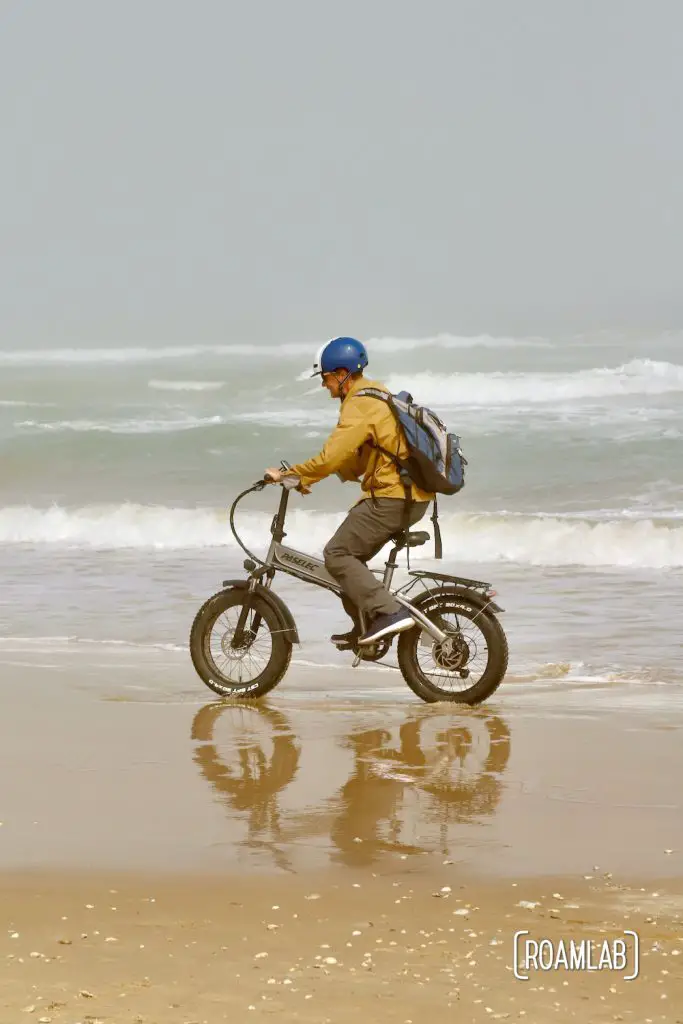 Man biking along the beach in South Padre Island, Texas