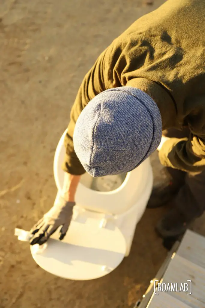Man looking into a toilet.