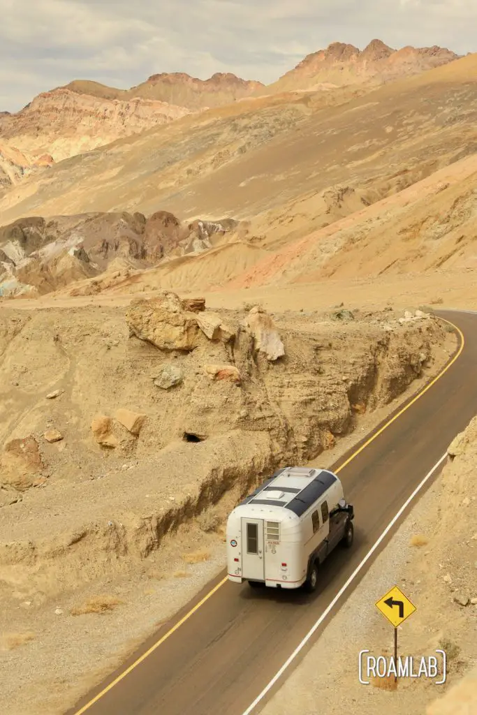 1970 Avion C11 truck camper driving through Artist's Road in Death Valley National Park.