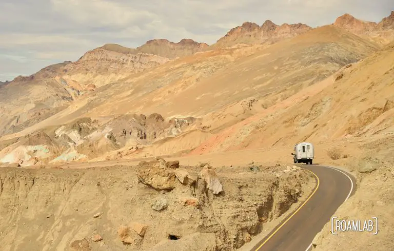 1970 Avion C11 truck camper driving through Artist's Road in Death Valley National Park.
