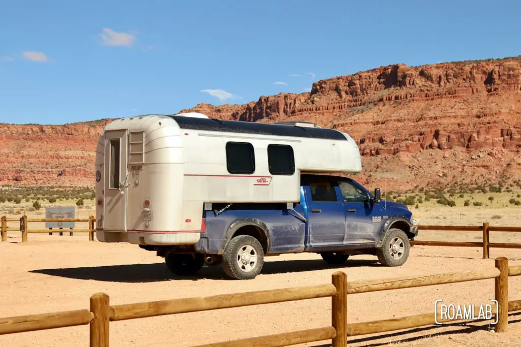 Dusty 1970 Avion C11 truck camper parked at the Condor Viewing Site with the Vermillion Cliffs in the background.
