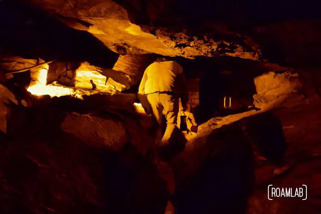 Man crawling through Tall Man's Misery on the Geology Tour of Mammoth Cave National Park.
