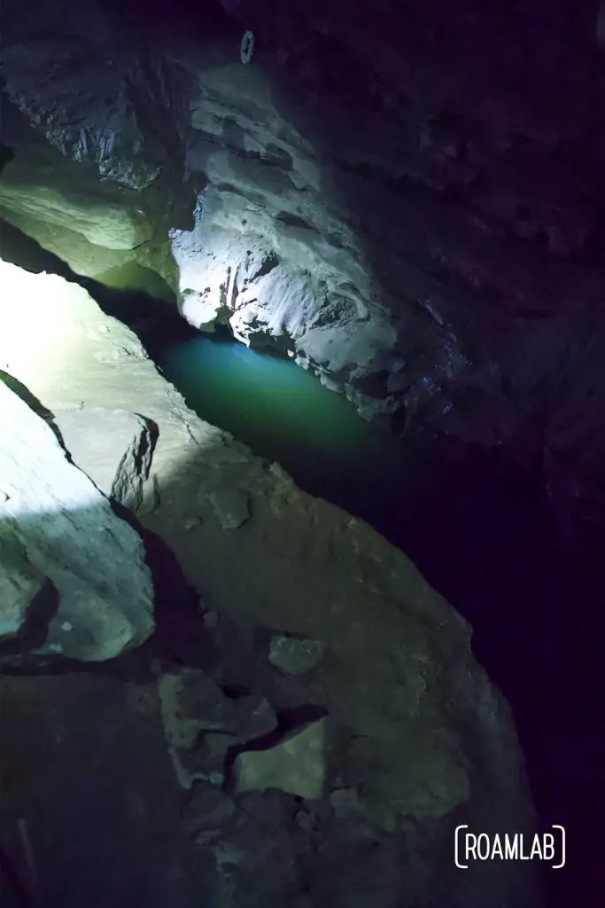 Flash light look down into the River Styx along the Geology Tour of Mammoth Cave National Park.