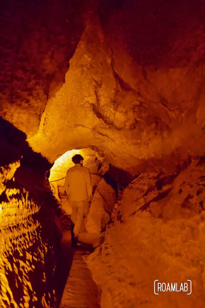 Man spelunking through the narrow passages on the Geology Tour of Mammoth Cave National Park.
