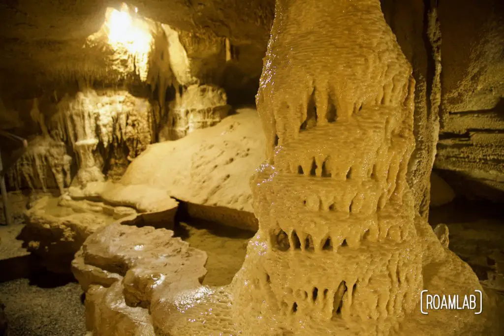 Gracefully dripping pillar and subterranean pool in Crystal Onyx Cave.
