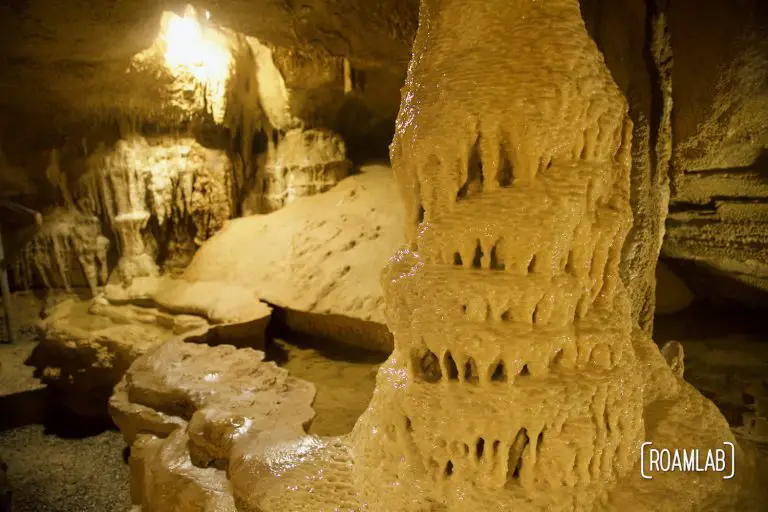 Gracefully dripping pillar and subterranean pool in Crystal Onyx Cave.